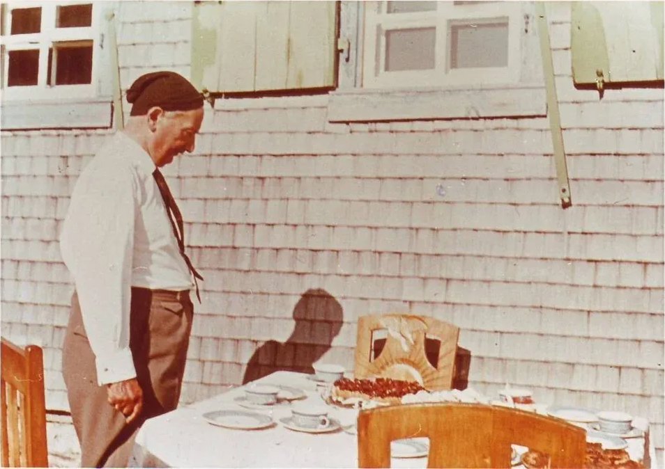 Heidegger staring at what looks to be some sort of fruit tart.