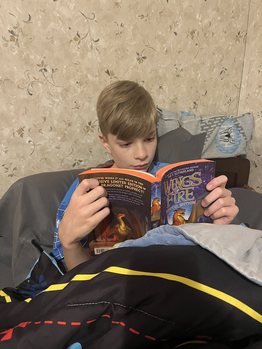 MrsMJH's tweet photo. After a field trip to see @Tui_sutherland , Mikey had to read “Wings of Fire” for the fourth time because “this one is autographed!” 😂❤️📚 https://t.co/F21ZRK2CQR
