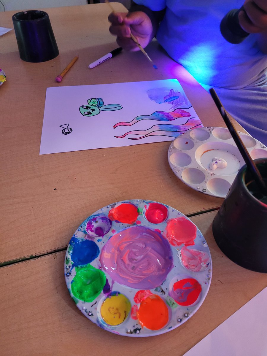 Ms. Lucot's class earned their blacklight art day, where they drew sea turtles and used neon colors that glow with the UV light.