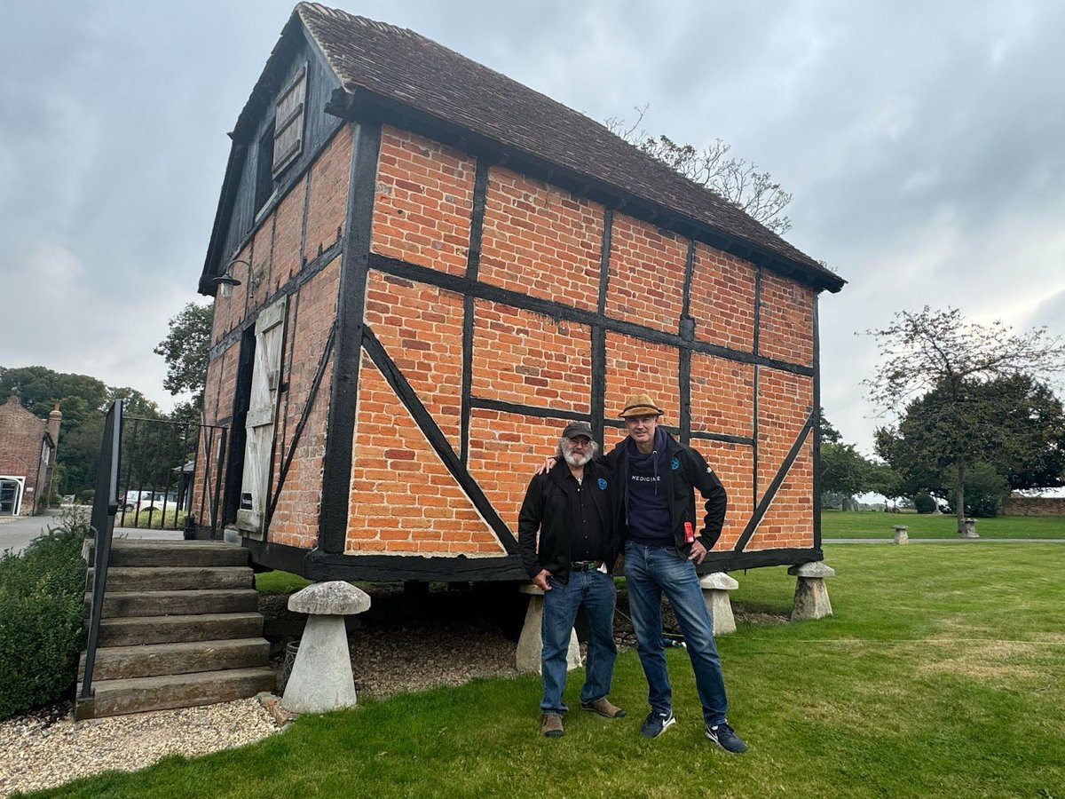 PaulStamets's tweet photo. Josh Dugdale and I stand in front of this incredible saddle stone supported cottage while I’m here in Wasing, England for #Equinox. Saddle stones supported grain storage for centuries in England preventing rodents from gaining entry and allowing air circulation for help preservation. The mushroom form can have many utilitarian uses! #Wasing1759