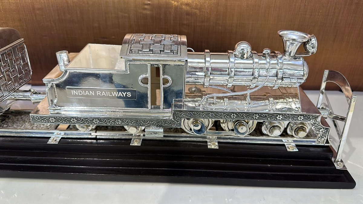 ANI's tweet photo. PM Narendra Modi gifted an antique silver hand-engraved train model to US President Joe Biden. This vintage silver hand-engraved train model is a rare piece, crafted by artisans from Maharashtra. Made of 92.5% silver, the model showcases the pinnacle of Indian metalworking artistry, with elaborate details achieved through traditional techniques such as engraving, repoussé (hammering from the reverse to create raised designs), and intricate filigree work. This is a tribute to the steam locomotive era.