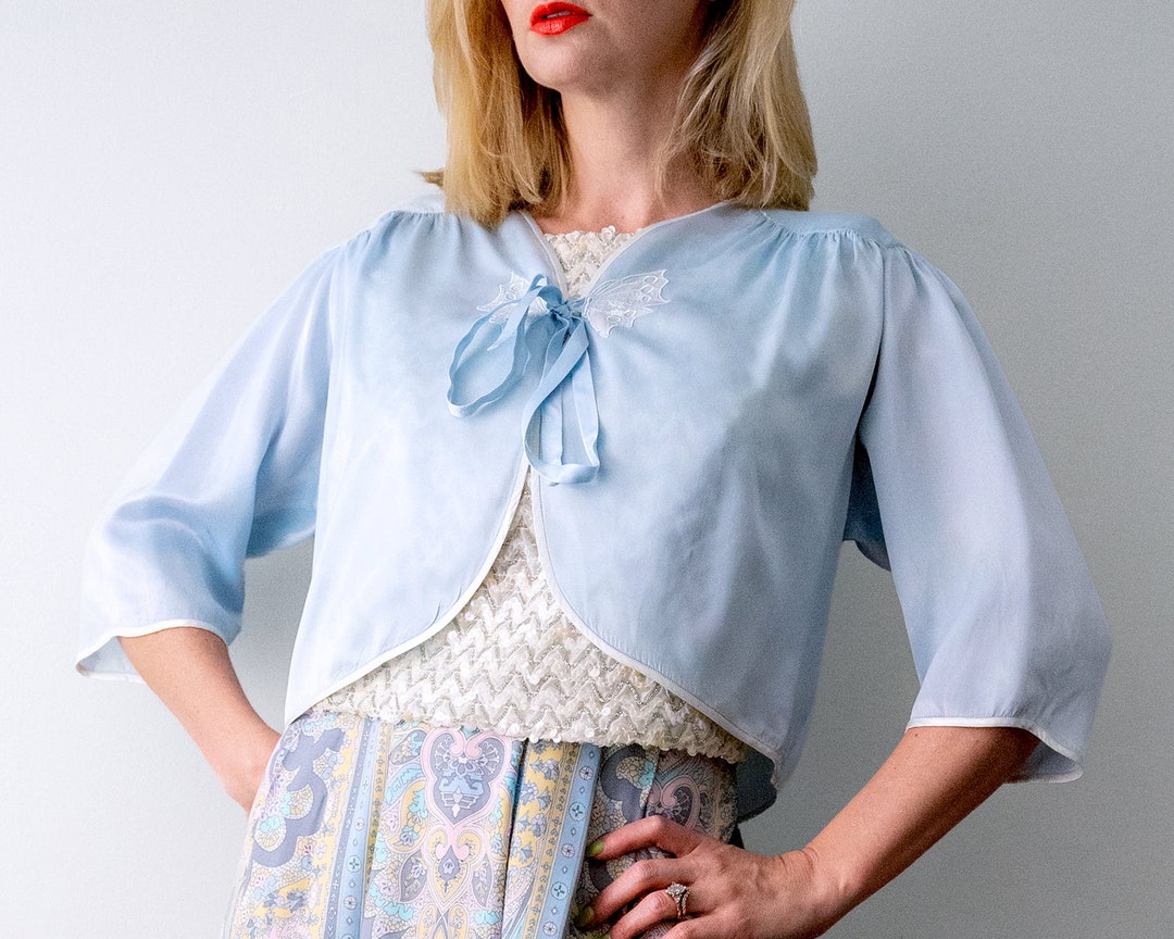 heirloomen's tweet photo. 40's vintage bed jacket. butterfly. 1940's light blue satin bed jacket. rayon blouse. ribbon. by heirloomen https://t.co/jni5lg8YBS https://t.co/eDv8G5Fz5l