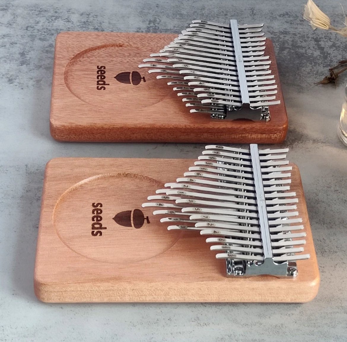 KiwiMbira's tweet photo. New Seeds 17, 21, 24, 34-key #kalimbas!
17k & 21k are made of black walnut (with wooden backstop), while 24k & 34k Mage is made of okoume, like 41k.
The 22-tone (34k) variation is called Gemini, & the melody can be played on the right with chords on the left side.
#kalimba https://t.co/TuthpiYPU7