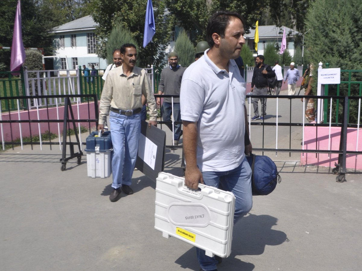 AsianNewsHub's tweet photo. InPictures: Ahead of second phase of assembly polls, officials transport EVMs and materials to their polling stations.
Photos #SahilMir https://t.co/rQVkGBkb2G