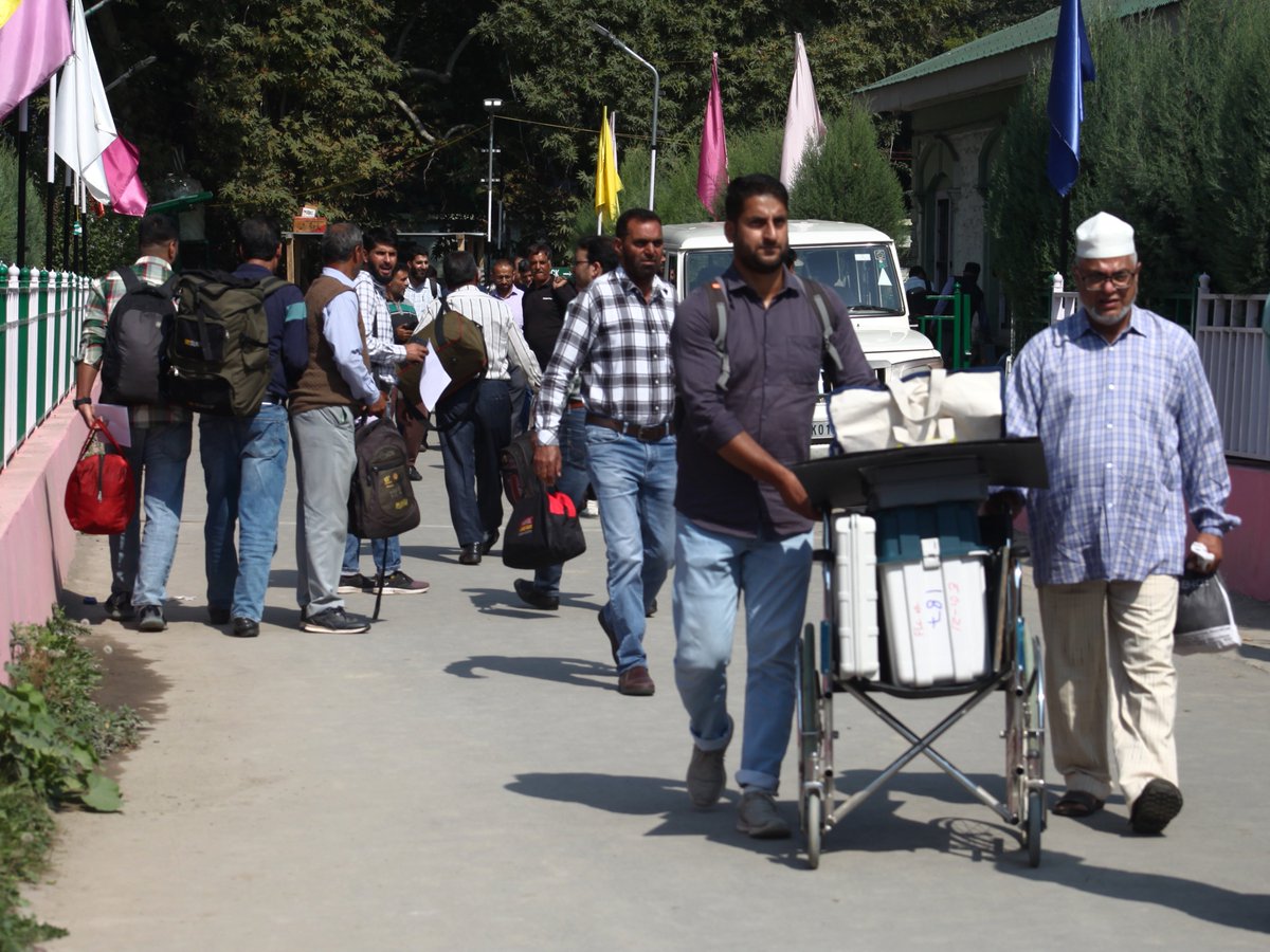 AsianNewsHub's tweet photo. InPictures: Ahead of second phase of assembly polls, officials transport EVMs and materials to their polling stations.
Photos #SahilMir https://t.co/rQVkGBkb2G