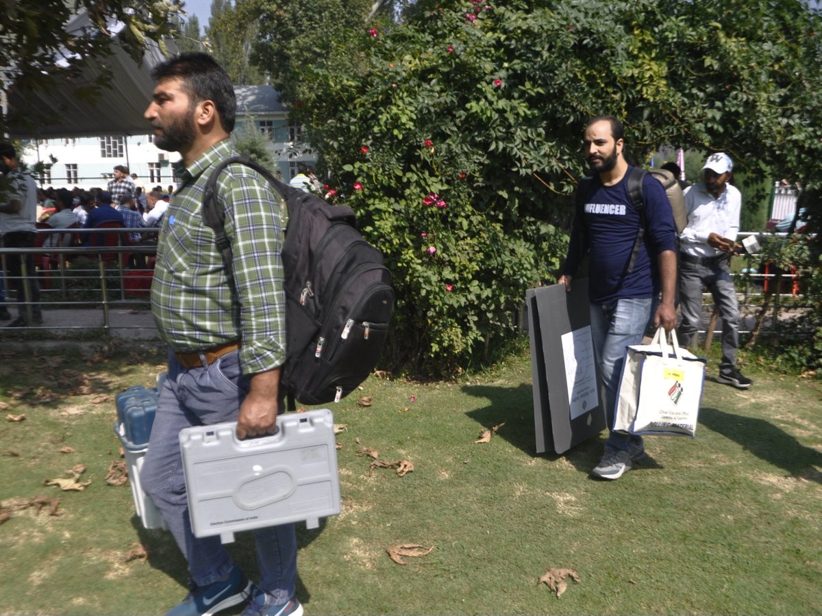 AsianNewsHub's tweet photo. InPictures: Ahead of second phase of assembly polls, officials transport EVMs and materials to their polling stations.
Photos #SahilMir https://t.co/rQVkGBkb2G