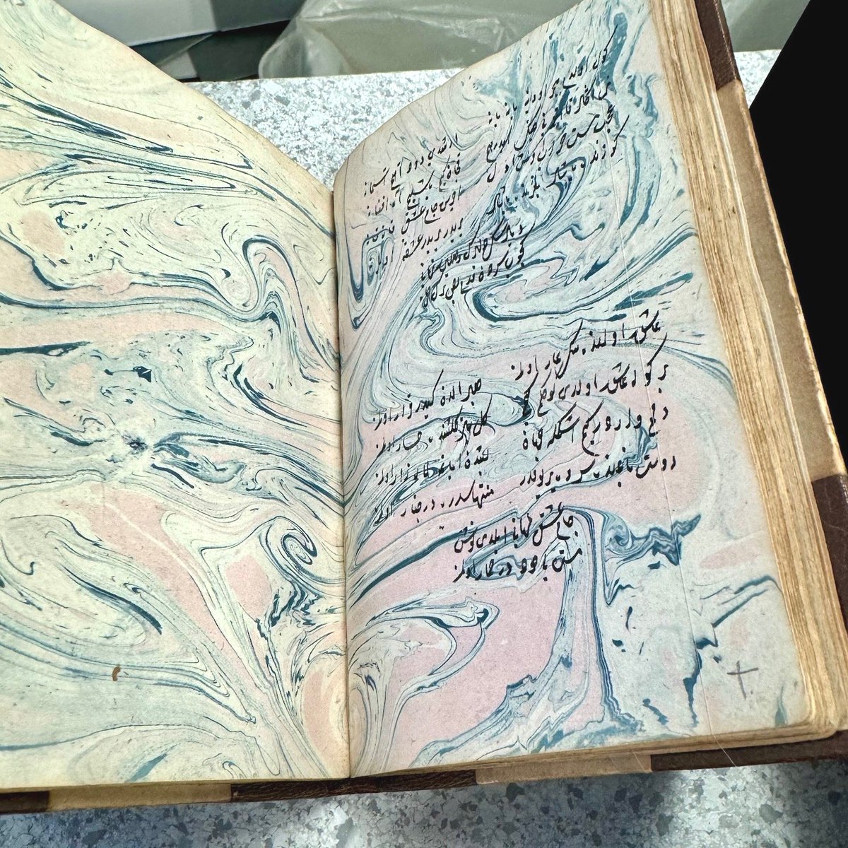 theUL's tweet photo. The #CULconservation team is preparing objects for our Endless Stories exhibition. Manuscripts are placed on a bespoke cradle and held in place with fine hair silk to keep them safe without obstructing the page!
#EndlessStories #ExhibitionInstallation #BookConservation https://t.co/WXFhgCVmMU