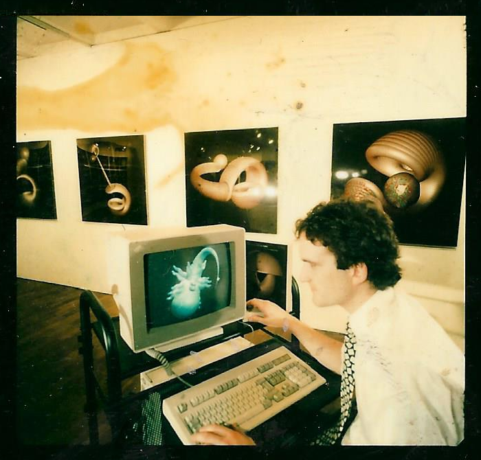 Damaged poloroid from 1988 at The Arnolfini Gallery in Bristol showing early Mutator forms. Emerged from the archive after many years. Cibachromes and pre-rendered forms on an IBM PC. Developed with Stephen Todd and Peter Quarendon (WINSOM CSG ray tracer).  #generativeart