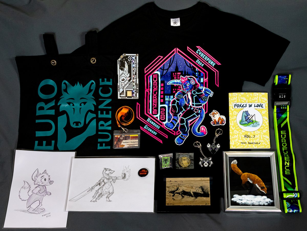 ValiantVulpine's tweet photo. And here's the obligatory #EF28 loot photo!

I won the Art Show auction for the artwork with the silver frame (made by @rivalmit). The artwork next to it with the black frame was made by @Alpha_Ki. I also got a really cool sketch and a button from the #pawpetshow.🧡

#Eurofurence https://t.co/KJ2DpgL7YQ