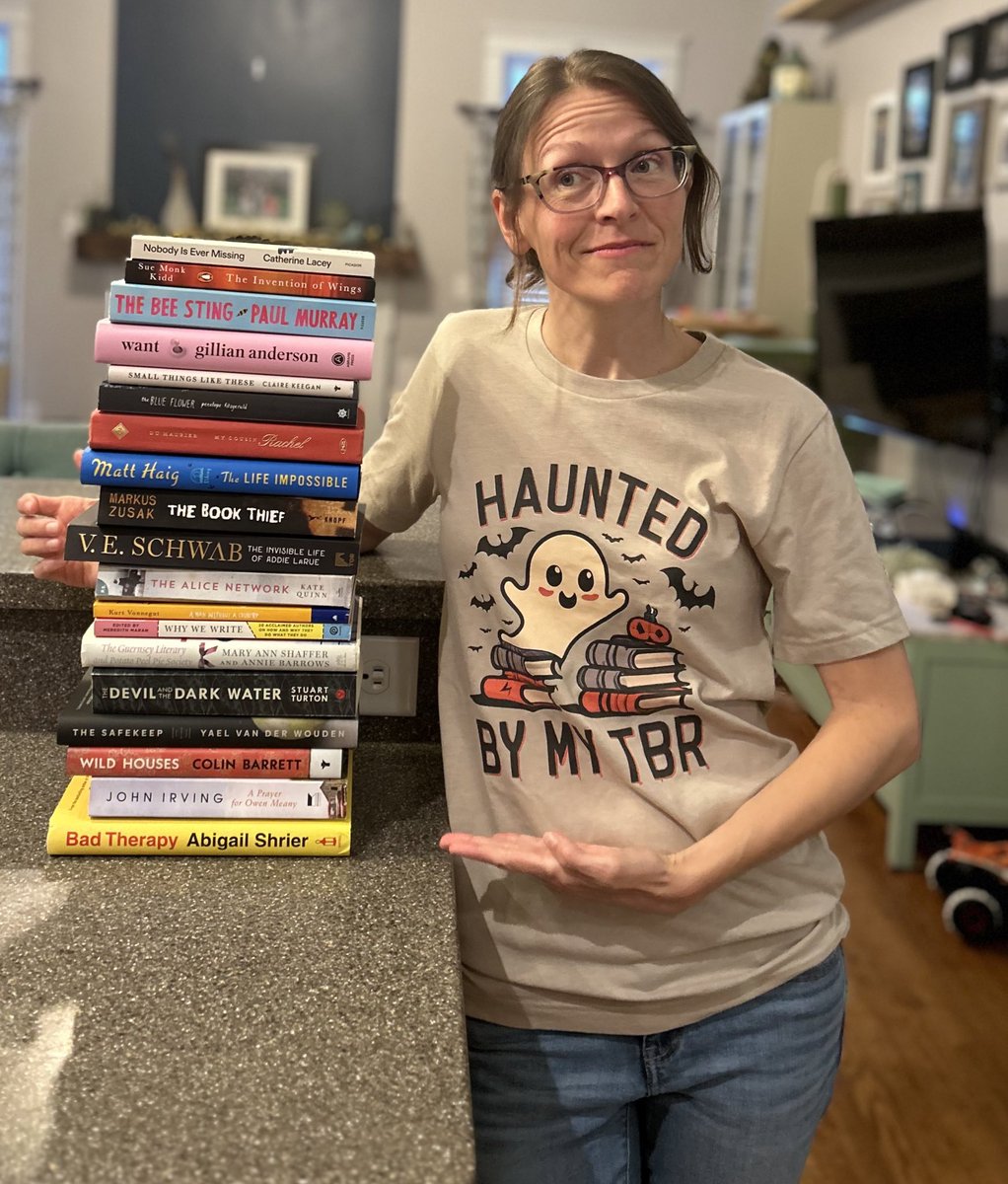 bowerspartyof5's tweet photo. Hi I’m Heather. If you didn’t already know that I’m kind of a goof, here’s this. A photo shoot with my new shirt and unread books. 😆 #tbr #books #whichonefirst https://t.co/HCJ4E4sEqe