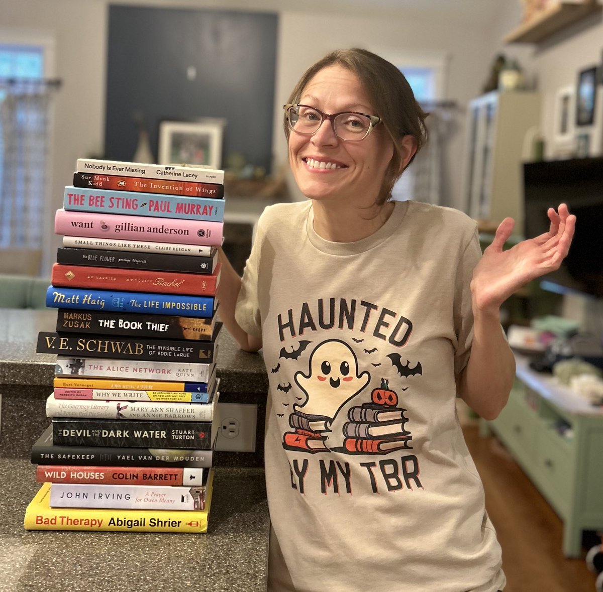 bowerspartyof5's tweet photo. Hi I’m Heather. If you didn’t already know that I’m kind of a goof, here’s this. A photo shoot with my new shirt and unread books. 😆 #tbr #books #whichonefirst https://t.co/HCJ4E4sEqe