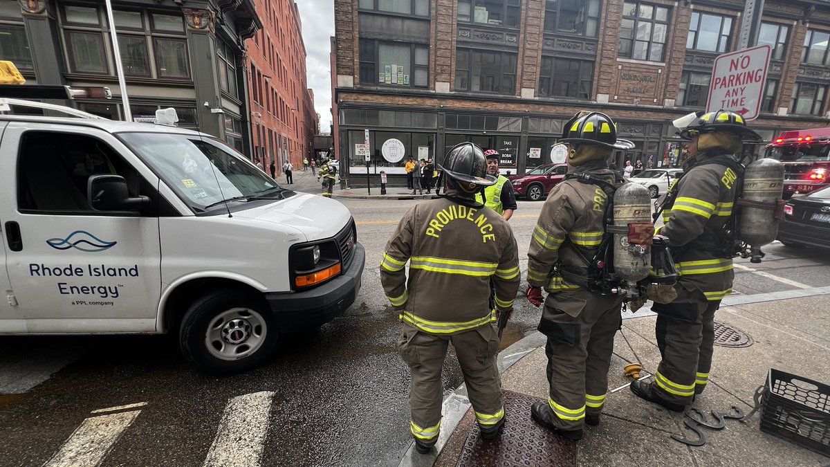 CoreyWelch's tweet photo. Some buildings have evacuated along Washington St in downtown Providence after people heard and felt a loud explosion. Appears at least one manhole cover blew off. Some smoke visible in the area right now. @wpri12 https://t.co/kBLNOv7WpQ