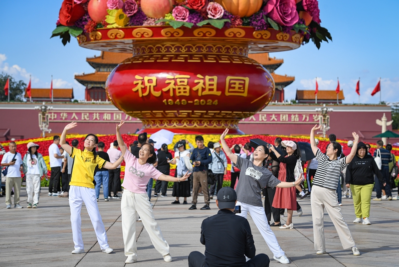 【“祝福祖國”蔬果花籃亮相北京天安門廣場】25日，“祝福祖國”巨型花籃亮相北京天安門廣場。“祝福祖國”巨型花籃頂高18米，以喜慶的蔬果花籃為主景，籃內除傳統的牡丹花、月季花等花卉外，首次選取了分別寓意福祿吉祥、喜慶豐收、紅紅火火的葫蘆、南瓜、辣椒等蔬果，體現“蔬果飄香、繁花似錦”。
