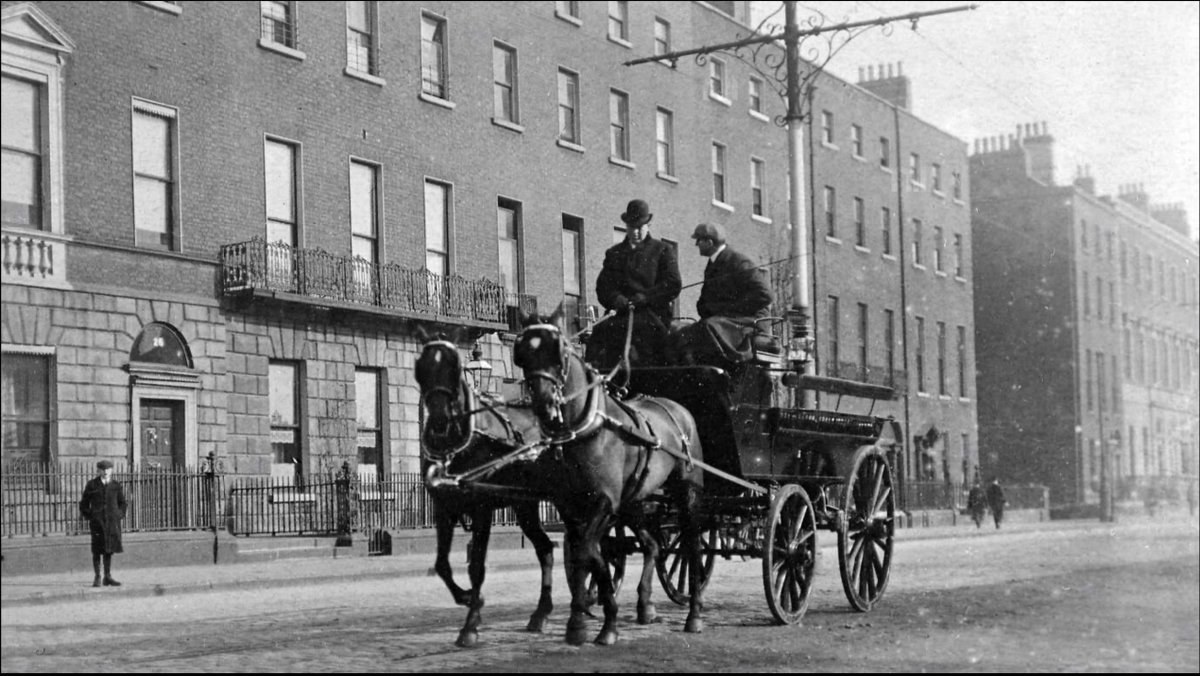 Carriage drawn by two horses, with driver and male passenger outside 26 Merrion Square, Dublin. From the Clarke Collection c. 1900