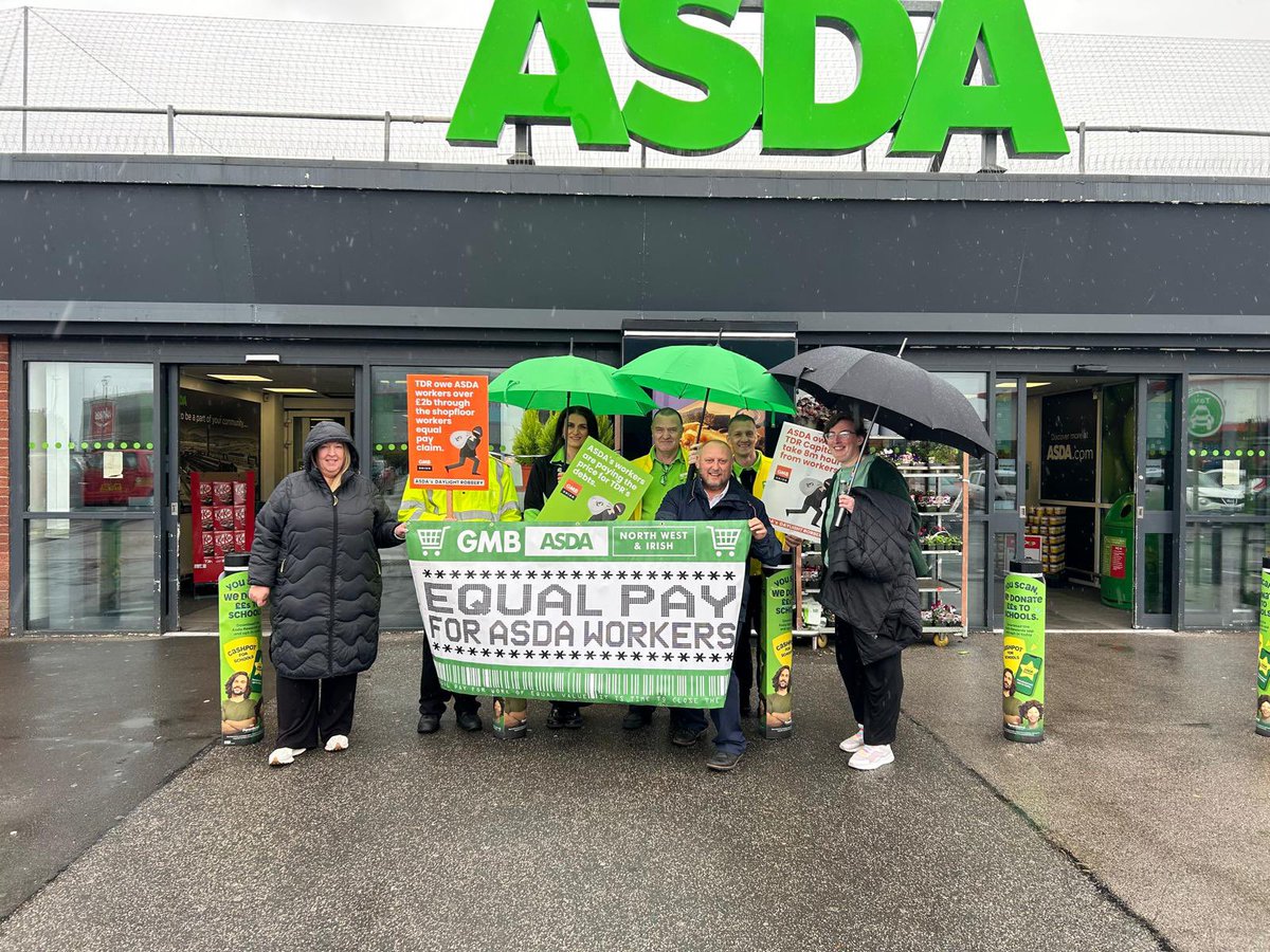 PaulThegrieve's tweet photo. Even the rain can not stop Asda colleagues protesting for equal pay without delay https://t.co/X48BrVxmKm
