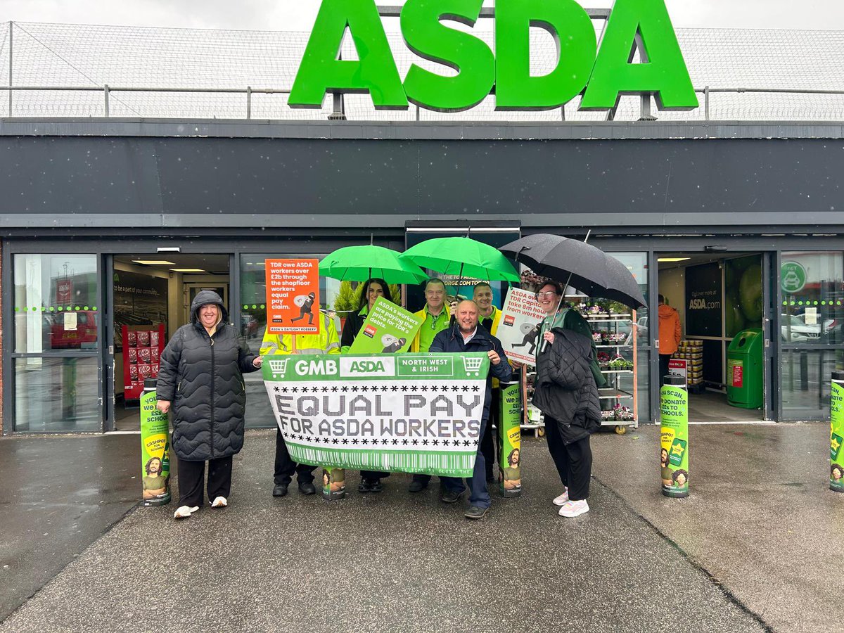 PaulThegrieve's tweet photo. Even the rain can not stop Asda colleagues protesting for equal pay without delay https://t.co/X48BrVxmKm