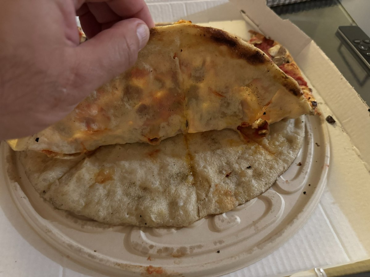 JoshTorok1's tweet photo. @PizzaExpress what on earth happened to my pizza? It has two bases. One sloppy one crispy and they are stuck in the middle but split the rest of the way. This is appalling that this went out the door!!! #ridiculous #fail https://t.co/PrxITKBrb3