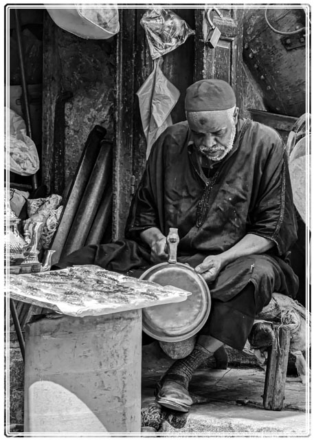 photos_dsmith's tweet photo. A #metalworker is working on a #metal #pot after taking to a #customer. #Fes/#Fez is #famous for its #skilled #crafts. Shot using #Nikon in #blackandwhite. #portraitphotography #streetphotography #blackandwhitephotography. #Follow or #visit our #website for more #images/#photo https://t.co/2nKr553U4y