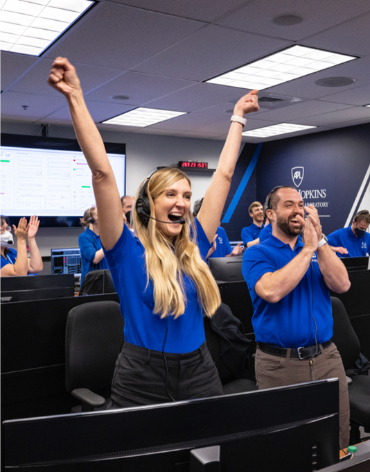 APL's Elena Adams and other mission team members celebrate the moment of DART Impact in the mission operations center at Johns Hopkins APL 