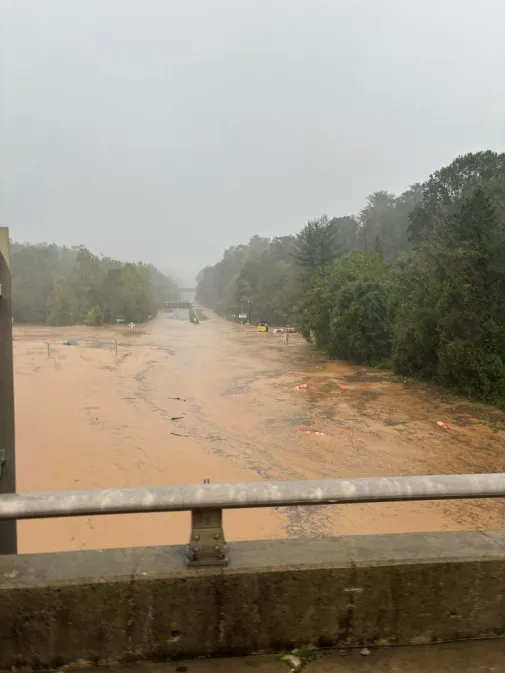 Left:  What standing on I-40, looking down at US 74 normally looks like.

Right: Same view, with flooding from the hurricane

(that's the Blue Ridge Parkway bridge in the distance)