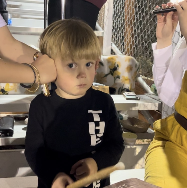 The band bringin on the pep at the football game - from our youngest cowbell player ever all the way up!