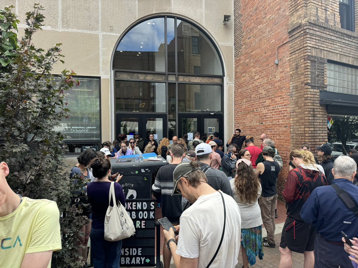 People trying to latch on to one of the only working WiFi networks in Asheville at the library.
