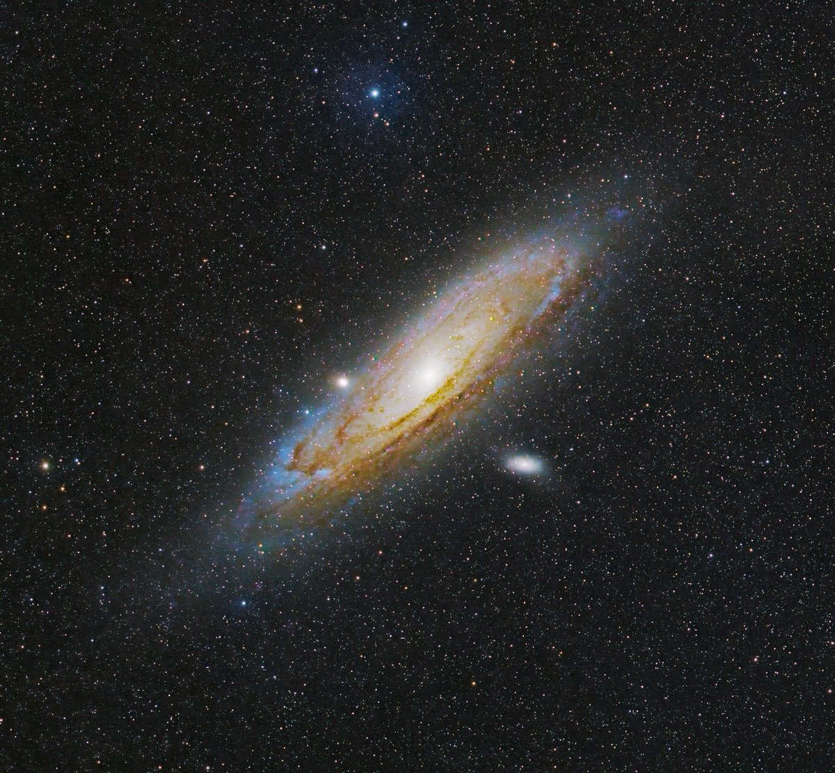 This photo of Andromeda Galaxy was captured using a surprisingly small camera lens. No telescope required! 

This was captured using about 2 hours of exposures with a tracking mount. This allowed me to compensate for the motion of Earth.