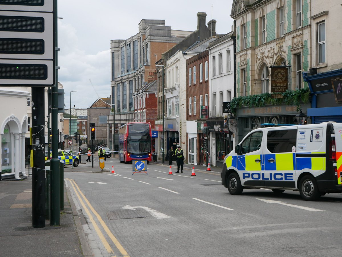 HamishBailey14's tweet photo. @dorsetpolice have partially cordoned off Commercial Road in the triangle with a @Morebusco bus also in the cordon. 

It is unknown why at this time. @Bournemouthecho 

#BCP https://t.co/ONU6W2YaFi