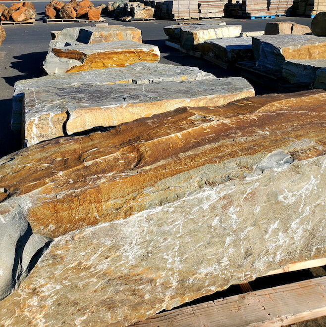 Check out McGregor Lake Boulders in action! This Northwest landscape boulder stone contains gold, bronze, brown, tans, and gray tones. Accented with a unique dendrite fern pattern embedded onto the surface, this stone has a distinctive appearance.#McGregor #stones