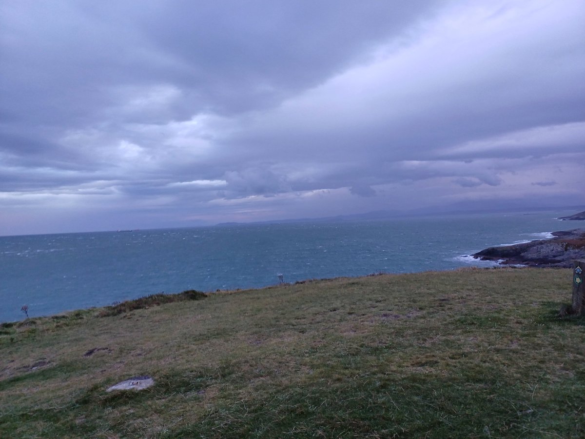 kendie's tweet photo. We've had tea and see the dolphins/porpoises from the window so wrap up and bob out. It's blowing a gale but rain has eased the sea is rough and we've watched the porpoises/dolphins crashing through the waves. #pointlynas #anglesey https://t.co/DtpWxCX6fr