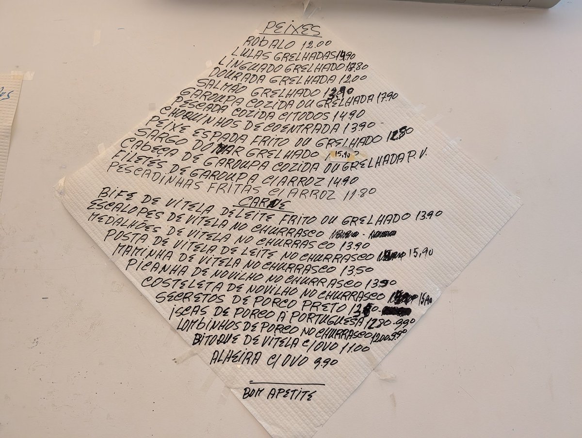 Menu written on the paper table cloth and taped to the wall ... 2/5