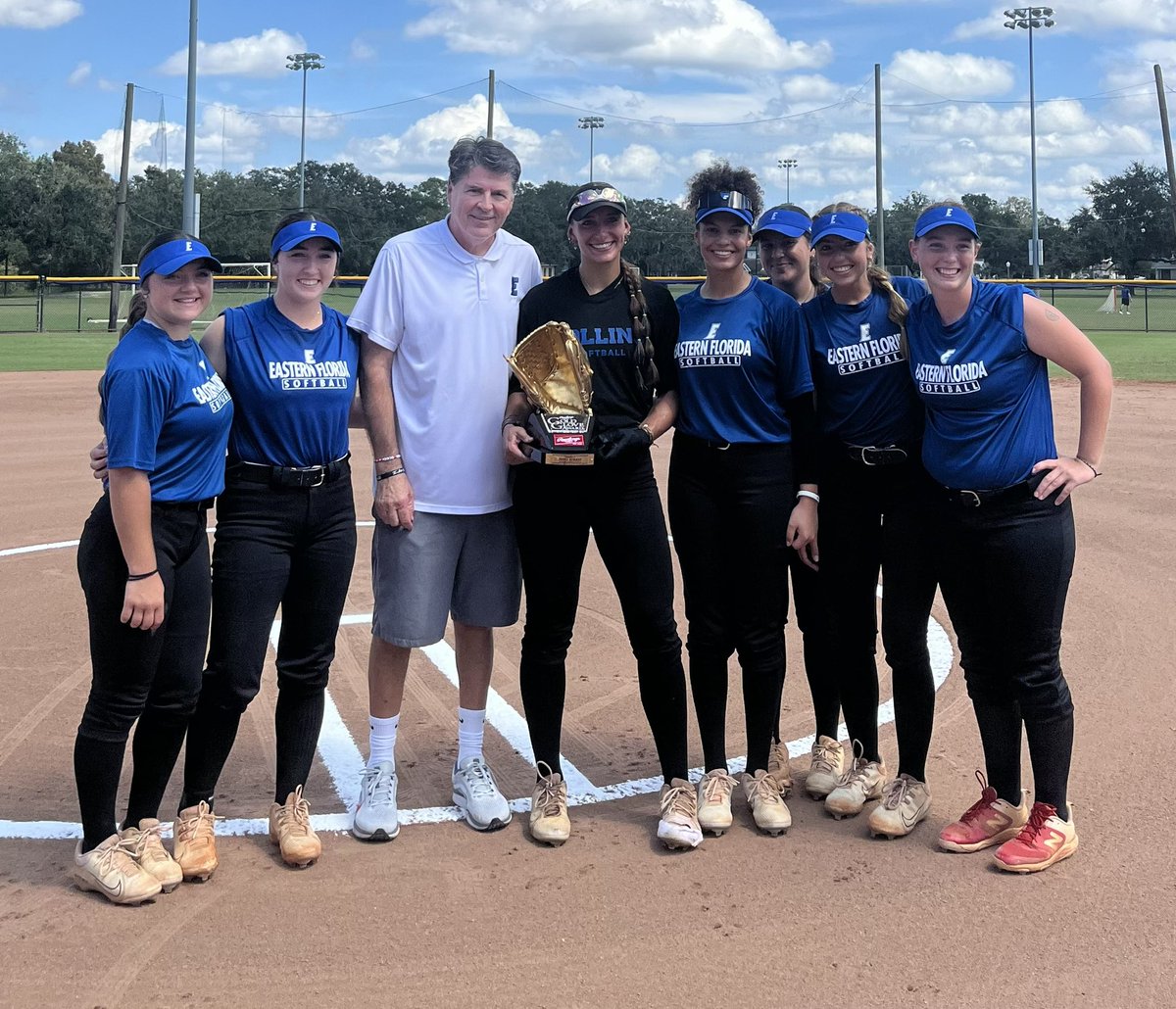 Former Titan Jenna Borkey poses with teammates after she received her Gold Glove Sunday at Rollins College where she now roams the outfield