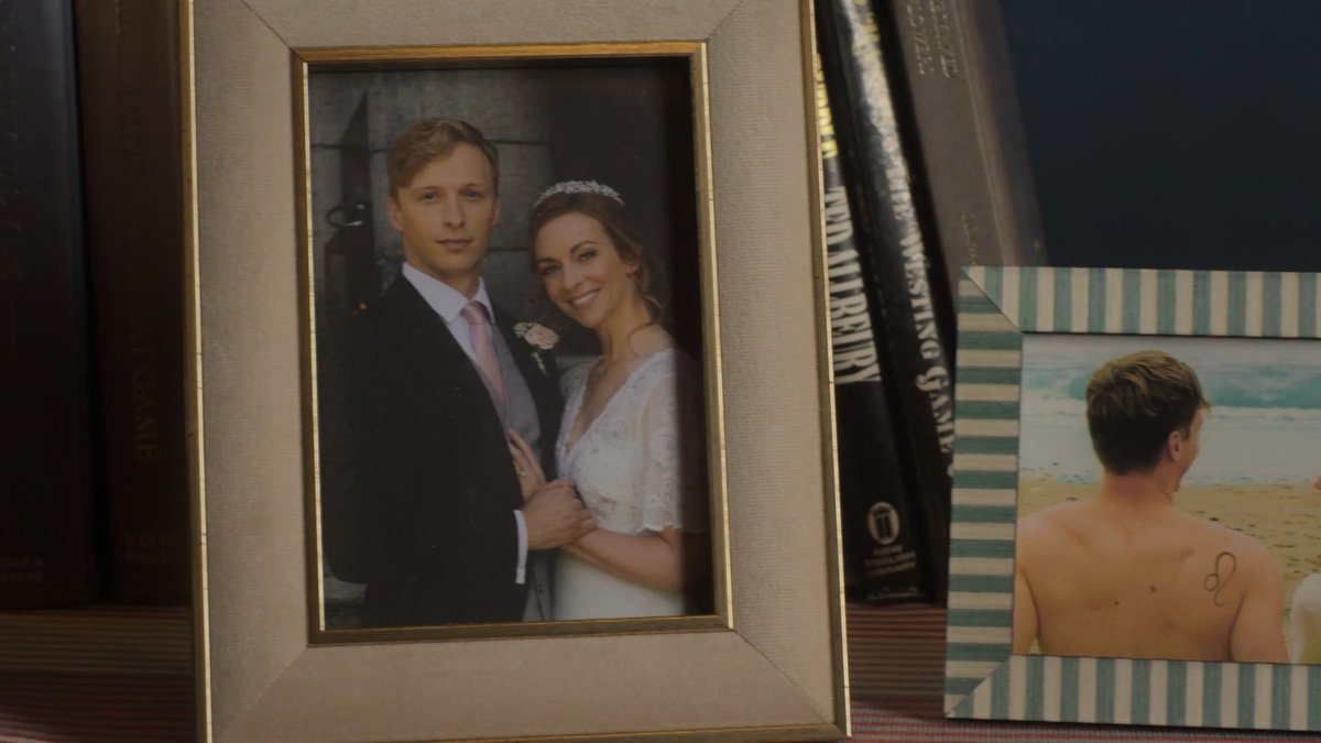 0bFuSc8's tweet image. Aiden told Susan he didn't read mystery novels, but look at the books on their sideboard.

I guess you could say Ted Allbeury's books are spy fiction, but The Westing Game is a mystery.
– Is Aiden lying or are they Cecily's (or just an Easter egg)?

#MoonflowerMurdersPBS