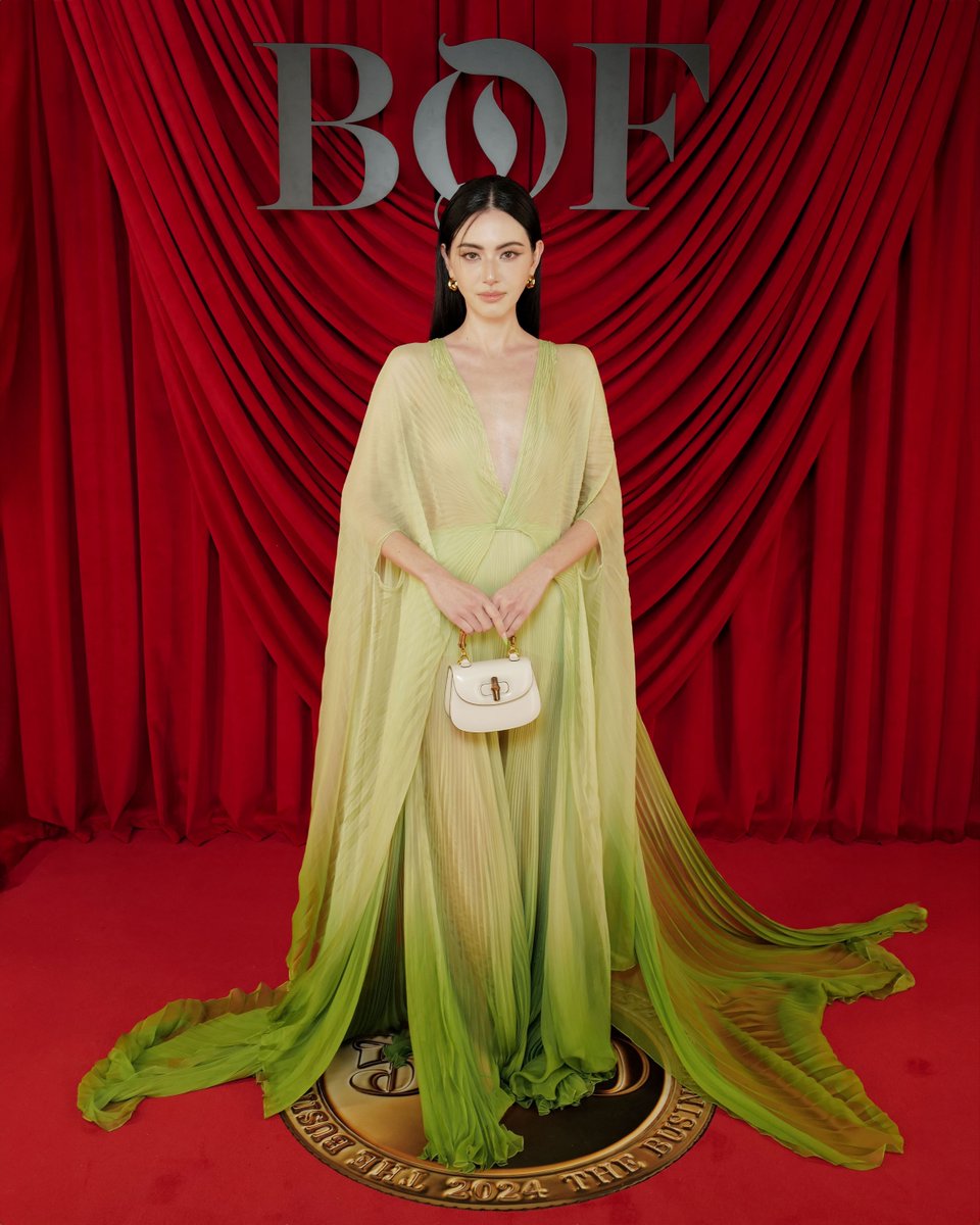 gucci's tweet image. In Paris, Brand Ambassador @DavikaH wore a #GucciCruise25 gown with a #GucciBamboo1947 bag. #DavikaHoorne