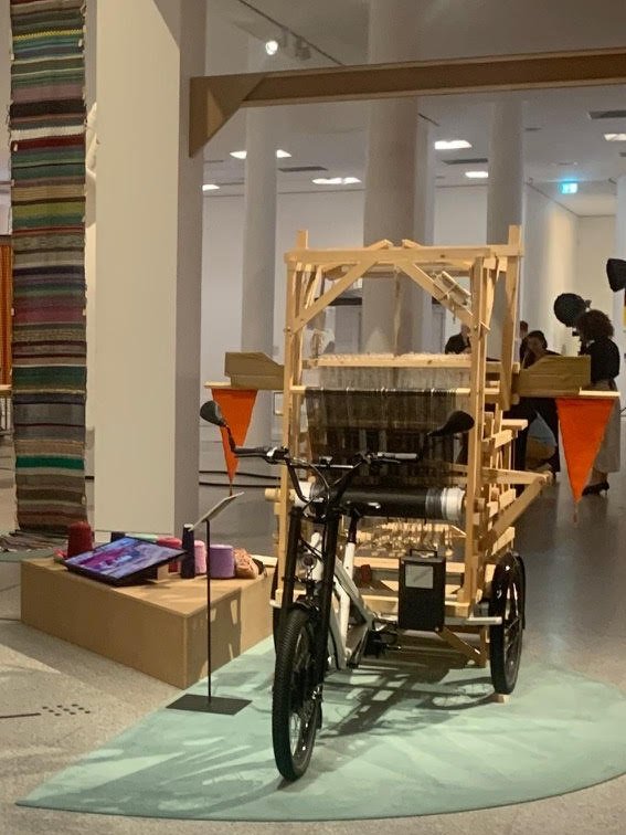 lizbarry's tweet photo. Participatory Democracy envisioned as Loom + Bicycle

loomcycle: a symbolic act of participation and involvement, dialogue, a community narrative — in which participants weave a flag too heavy for any nation state to fly 
https://t.co/DASLxIHD8W https://t.co/w5WxKiCpe3