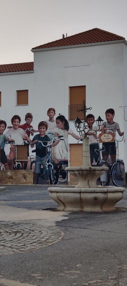 De una foto que les hicieron de pequeños en sus bicis, uno de los niños que ahora es artista ha hecho este mural en una fachada de Tamurejo (Badajoz).