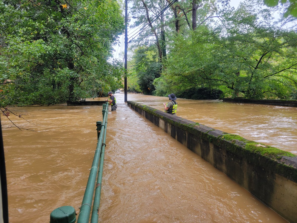 USGS_SAWSC's tweet photo. During floods caused by #TSHelene, #SAWSC Hydrologic Technicians Ahmed Rhoni-Aref and Jarrod Henderson recorded a wire-weight gage-height reading during near-peak stage at Nancy Creek at West Wesley Rd at Atlanta, GA (02336410). https://t.co/5VZ968FkYm #TechTuesday https://t.co/3u0GxSQTep