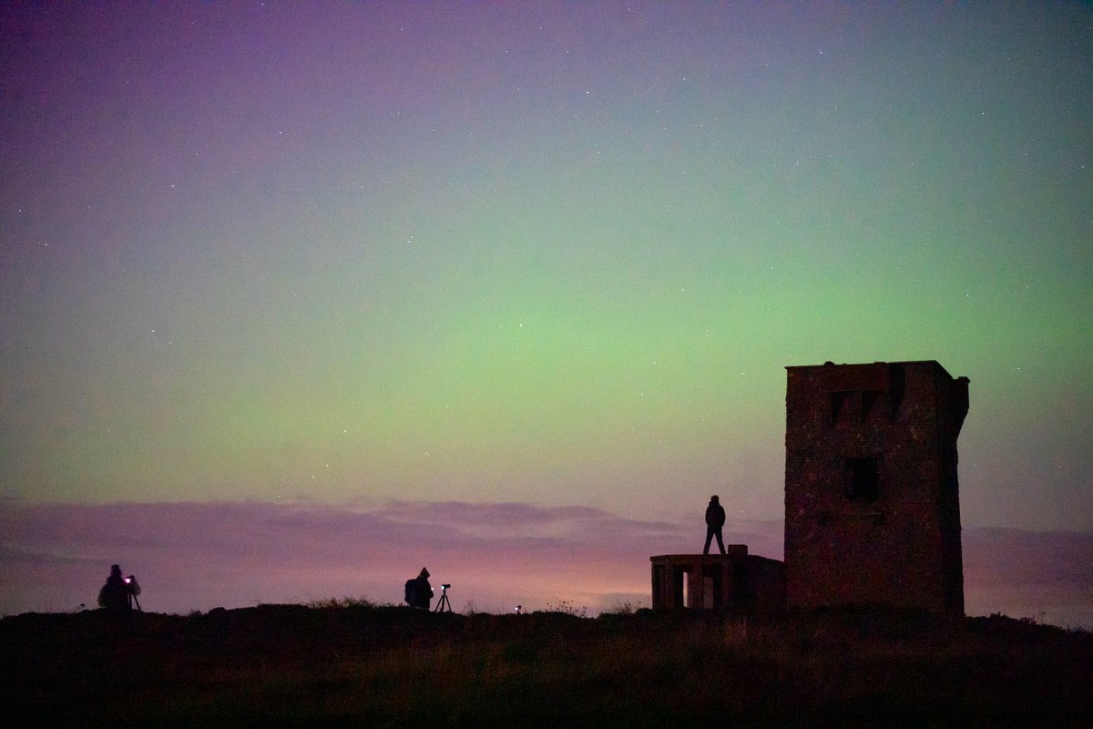 Photographers pose for images of the #northernlights over Knockadoon Signal Tower in east Cork last Thursday night cianoregan.com