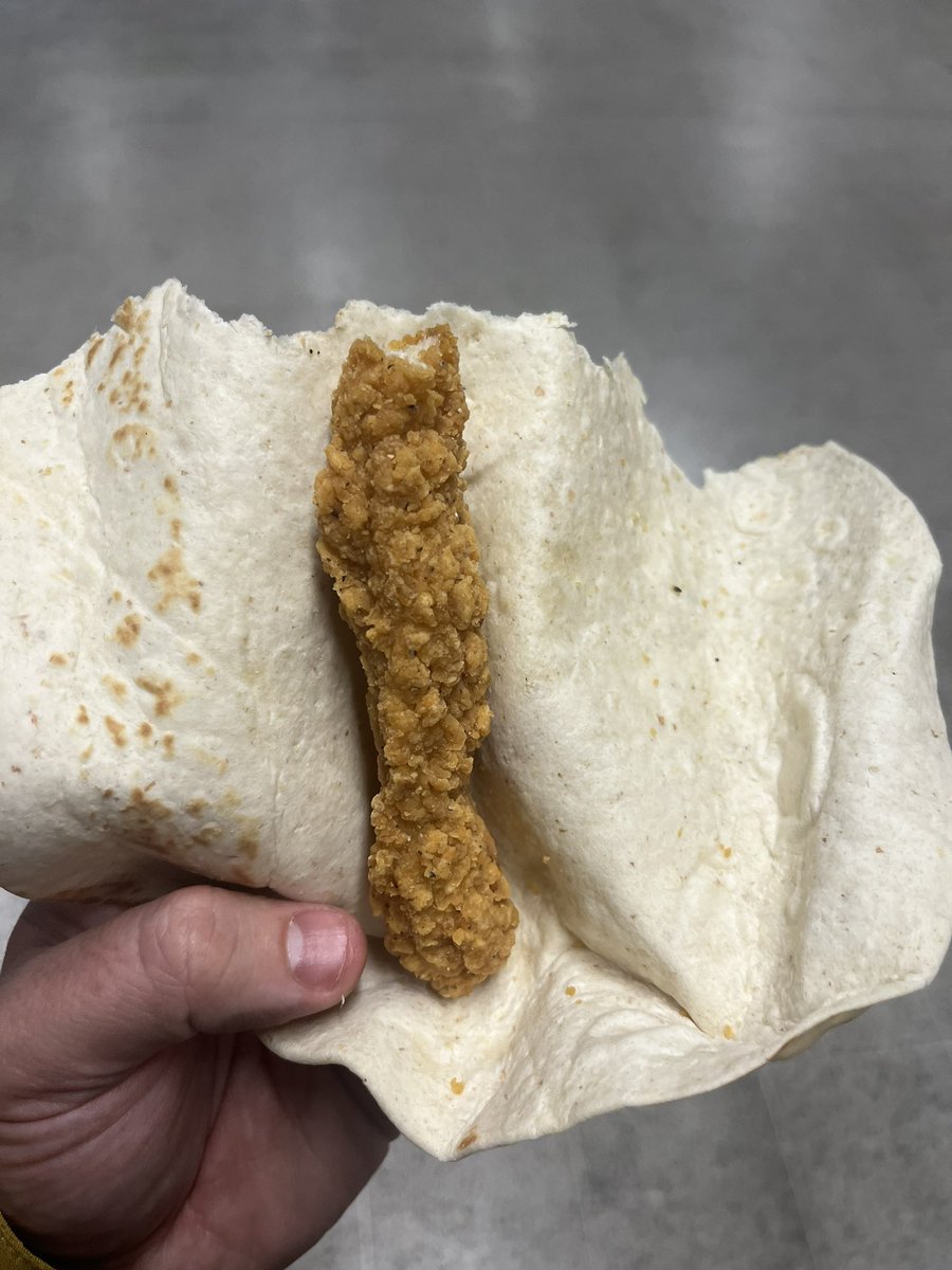 dave_id_b's tweet photo. @McDonaldsUK ordered a chicken and bacon Caesar wrap from your London Liverpool Street store yesterday… this was the wrap after 2 bites… no bacon, no sauce, no salad… absolute shambles! https://t.co/eGcPMdX8pn
