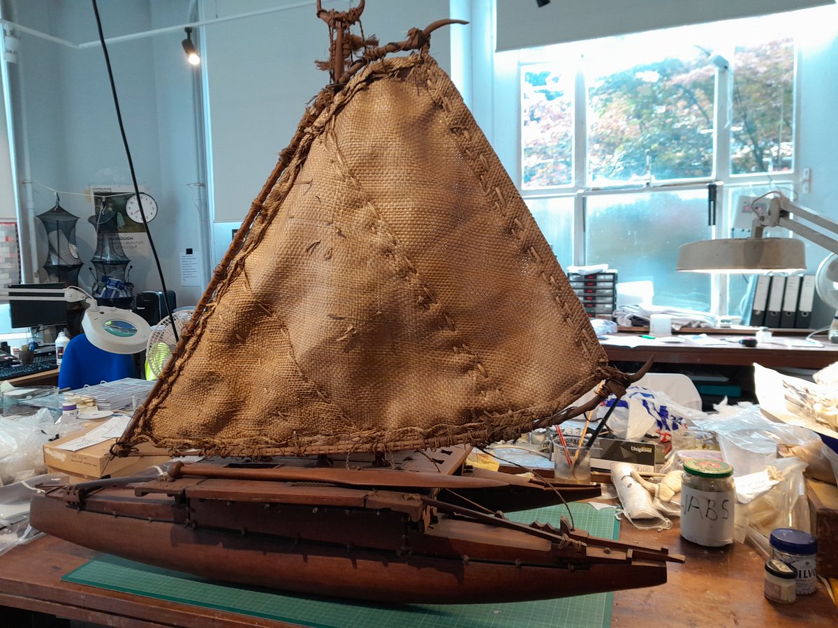 ConservationBob's tweet image. Ipswich Museum conservation. A volunteer has been cleaning a Fijian model outrigger canoe presented in 1925. The model is made of wood with vegetable fibre sail and cabin, wooden oars and bailers. Cleaned with a vacuum, a smoke sponge and swabs. Treated with microcrystalline wax.