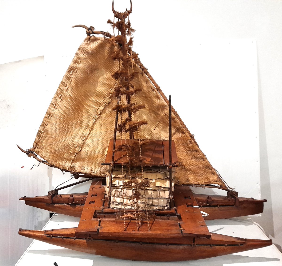 ConservationBob's tweet image. Ipswich Museum conservation. A volunteer has been cleaning a Fijian model outrigger canoe presented in 1925. The model is made of wood with vegetable fibre sail and cabin, wooden oars and bailers. Cleaned with a vacuum, a smoke sponge and swabs. Treated with microcrystalline wax.