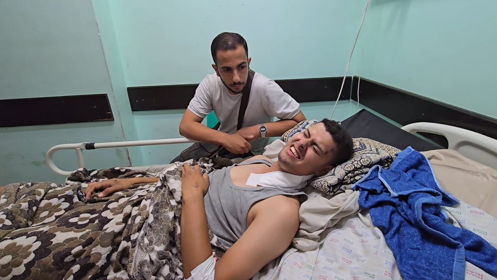 HossamShabat's tweet photo. Urgent Appeal:
My friend and Al Jazeera cameraman, Fadi Al-Wahidi, has suffered a severe decline in health after being shot by an Israeli sniper while clearly identified as press.
We are trapped in northern Gaza under siege.
Without immediate medical treatment abroad, his life is in grave danger.
I urge all relevant organizations to assist in facilitating his urgent transfer for treatment. Your support could save his life.
 #SaveFadiAl_Wahidi