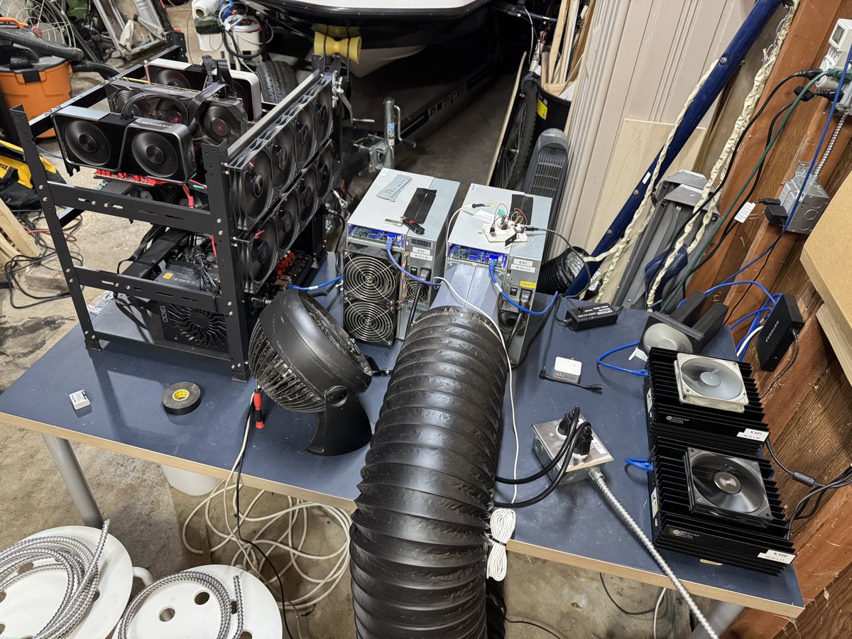 kritch83's tweet photo. My stupendous mining setup. Little shanty I know 🤣.  KS2, KS1, 2x KS0 Ultras, a 6x GPU Rig &amp; an ikea table.  Mining ➡️ @KaspaCurrency @NeoxaNet &amp; @zilliqa #Crypto #CryptoMining https://t.co/Y6OziHSOg0