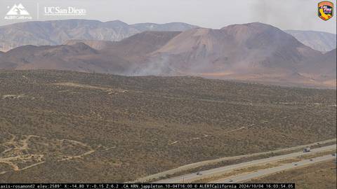 CodeRed001Blue's tweet photo. 10/4/2024 VEGETATION FIRE #RubyFire Ruby Ave off 30th St W, north of Rosamond, Kern County. [watchduty] 
4:04PM Reported vegetation fire with a response en route &amp; smoke showing on the Rosamond 2 ALERTCalifornia | UC San Diego camera. https://t.co/GmlamXr0ic
