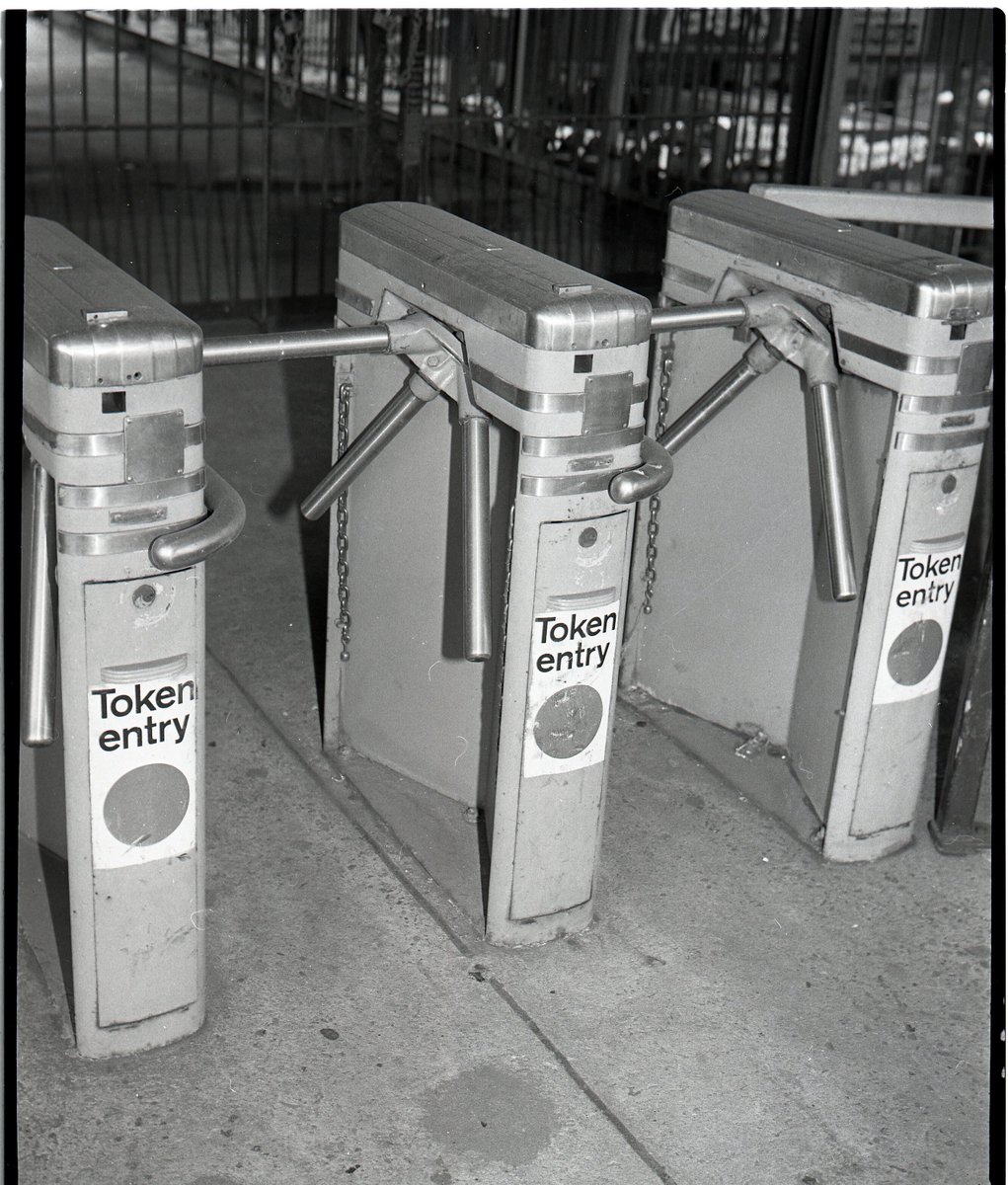 NYTransitMuseum's tweet image. #NowOnView in our #TicketToRide exhibit, this #NYTMCollection photograph shows an IND turnstile in the 1970s. In addition to introducing curvilinear forms, the designer, John Vassos, changed the number and angle of the arms to allow the units to be placed closer together.