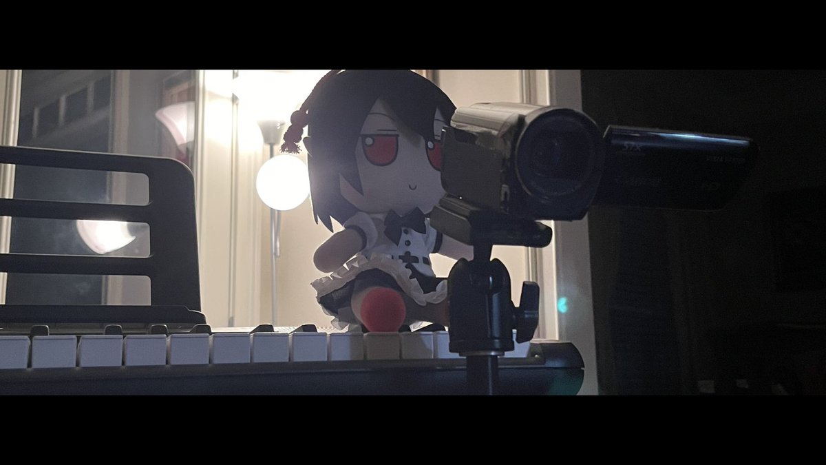 devvysen's tweet photo. I set up the lighting in the background, then I put an Aya Shameimaru Fumo on a Casiotone keyboard for the plush to sit on and put a Canon Camcorder on a Silk tripod in front of the plush. I took some pictures with this setup and then I added the cinematic crop. https://t.co/mlDiX5twda