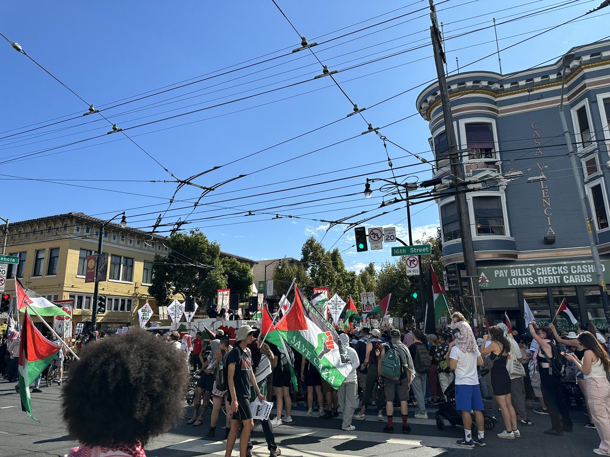 _chrisalam's tweet photo. Right now: large rally at 16th and Valencia protesting one year of Israel’s genocide in Gaza and recent attacks on Lebanon. #SanFrancisco #breaking https://t.co/gutmDvVNPg