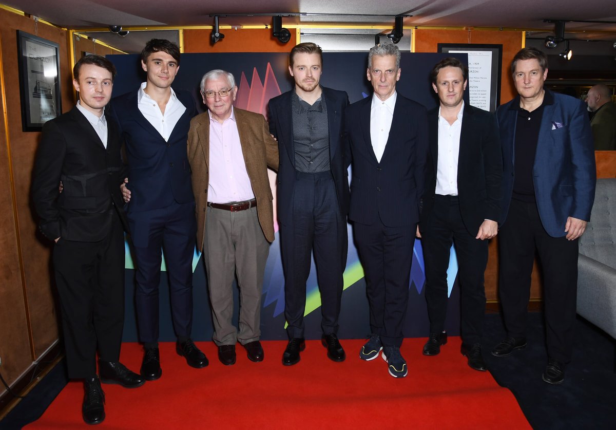 brinatello's tweet photo. October 7, 2023: A year ago today we lost legendary British screenwriter and film director #TerenceDavies. 😢💔 I saw #Benediction and thought it was very good. Here he is with the film's cast and getting a hug 🫂 from #PeterCapaldi (#SiegfriedSassoon). #RIPTerenceDavies 🎬💐❤️ https://t.co/eSS1uUZ64D