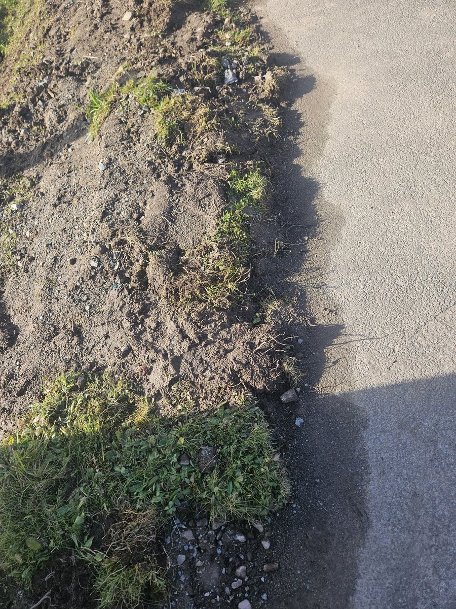 K99REA's tweet photo. @ShropCouncil Shocking the quality of this work. No replacement edging, tarmac into the grass. Not leveled and seeded, Soil on the pathway. Gledrid LL145DG https://t.co/yM2yae3dWk