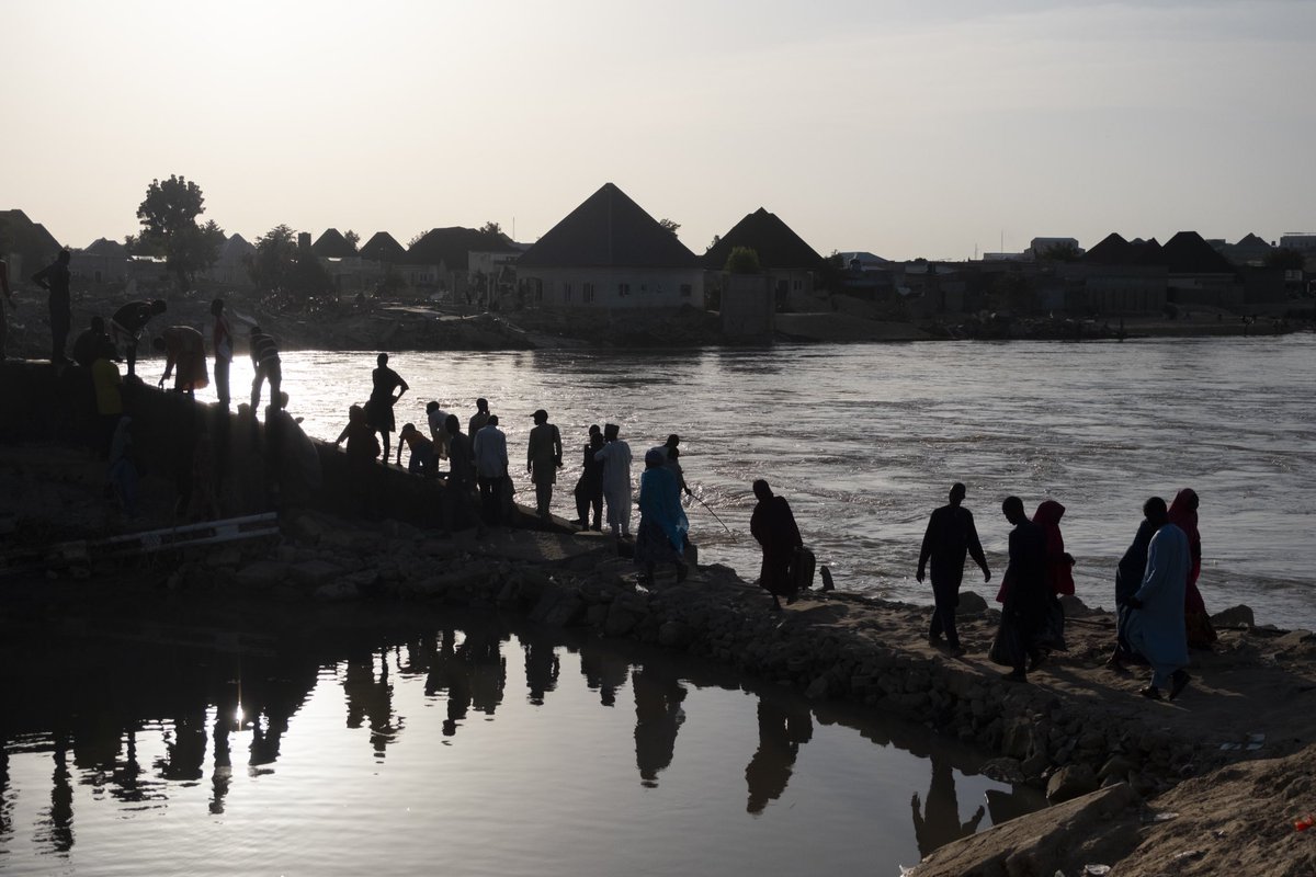 At sunset, people are seen walking around the Fori bridge, which was ravaged by floodwaters. 

The devastating floods in #Maiduguri have resulted in significant damage to the town's infrastructure, particularly the destruction of key roads and bridges that link the community.